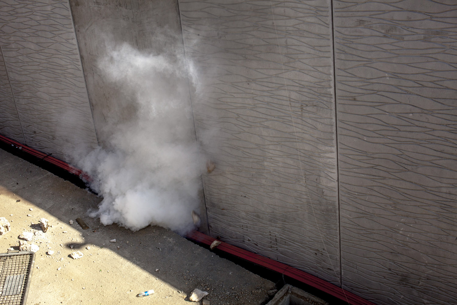 A tear gas round lands in the construction site of the proposed mall, mosque and shopping complex in the Gezi Park area of Istanbul.
