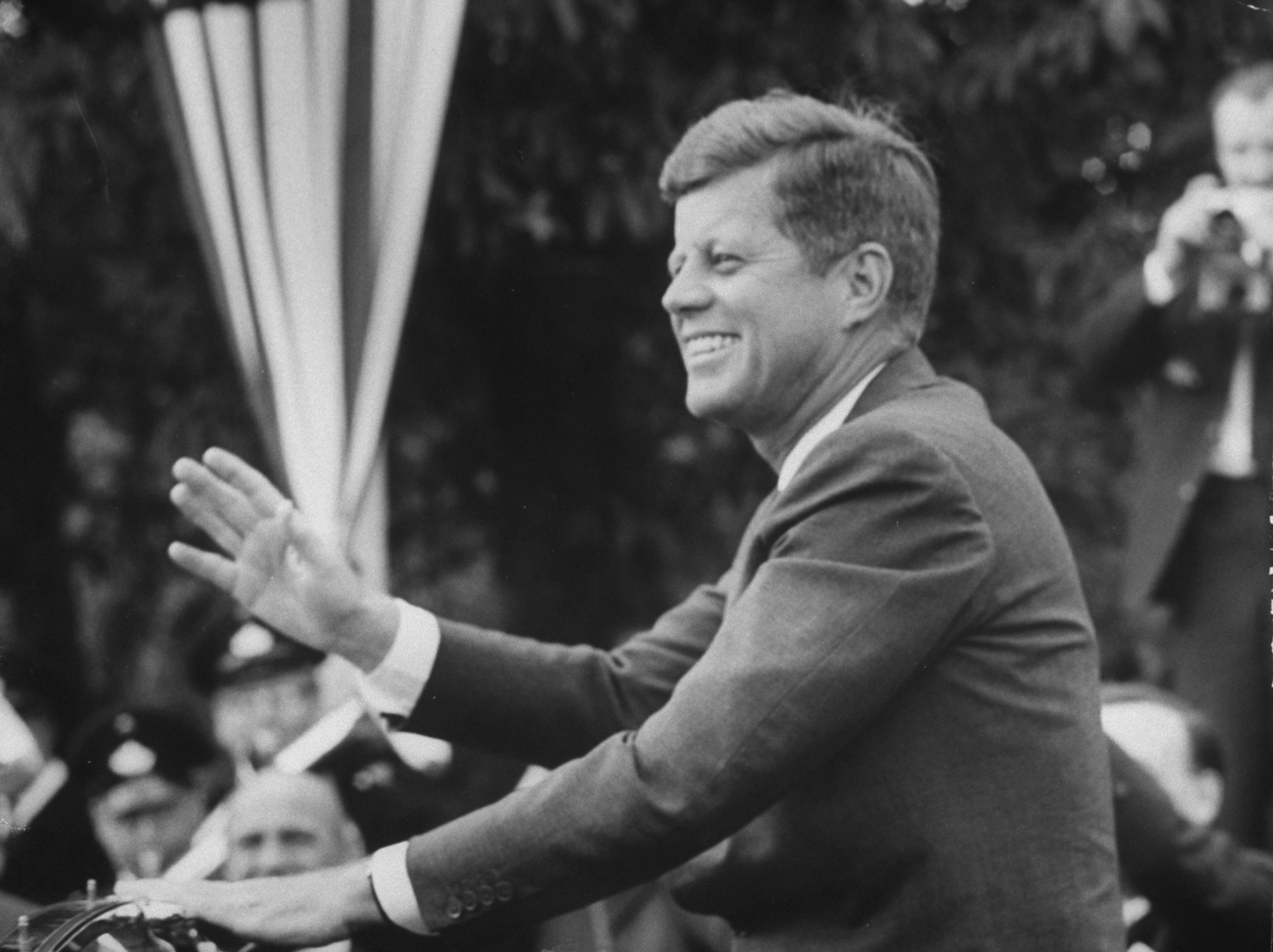 President John F. Kennedy waves at crowd during speech in Bonn, Germany, June 1963.