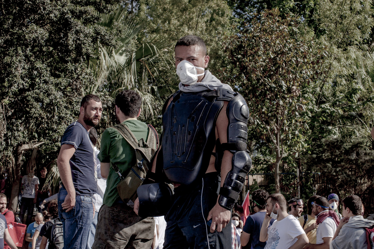 A protester wears the clothing of Istanbul's riot police as he watches the chaotic scenes around Gezi park.