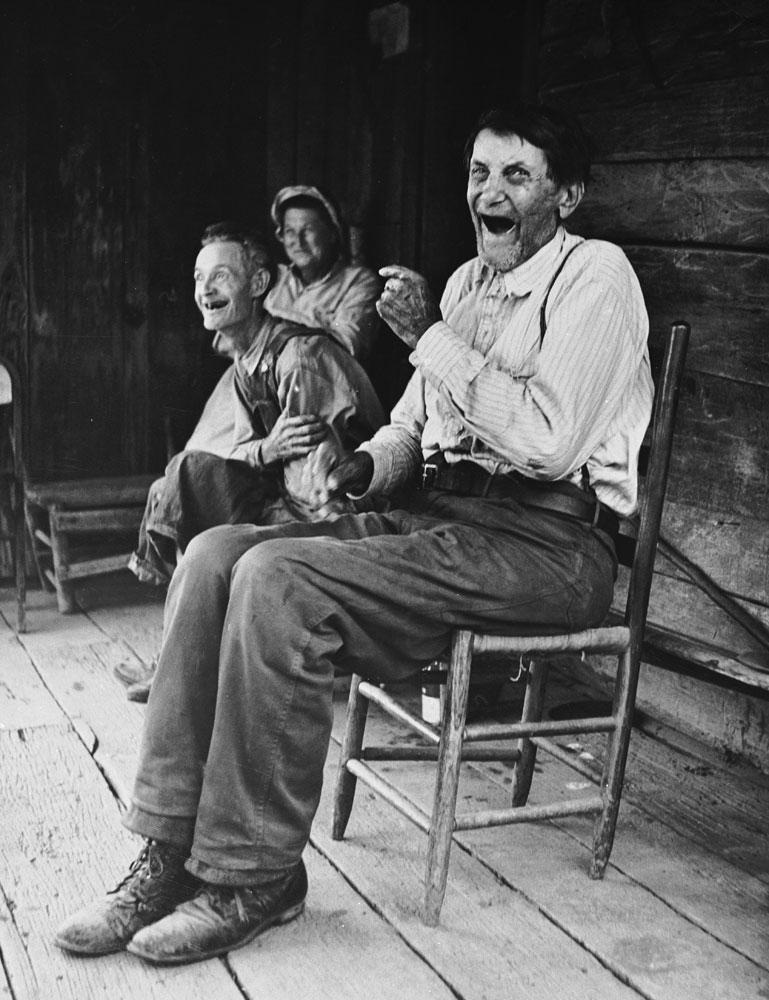Self-proclaimed Civil War vet John Salling shares a laugh with friends on his front porch in Scott County, Va., in 1953.