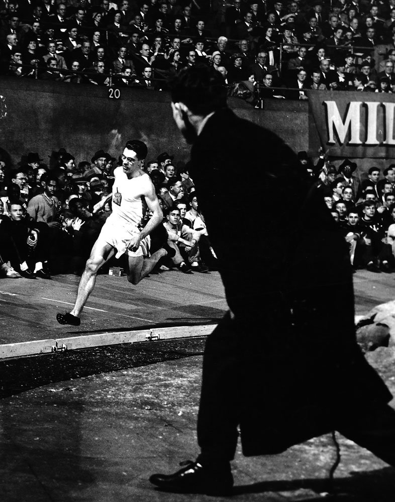Runner Gil Dodds, "The Flying Parson," on the third lap of his record-breaking indoor mile, New York, January 1948.