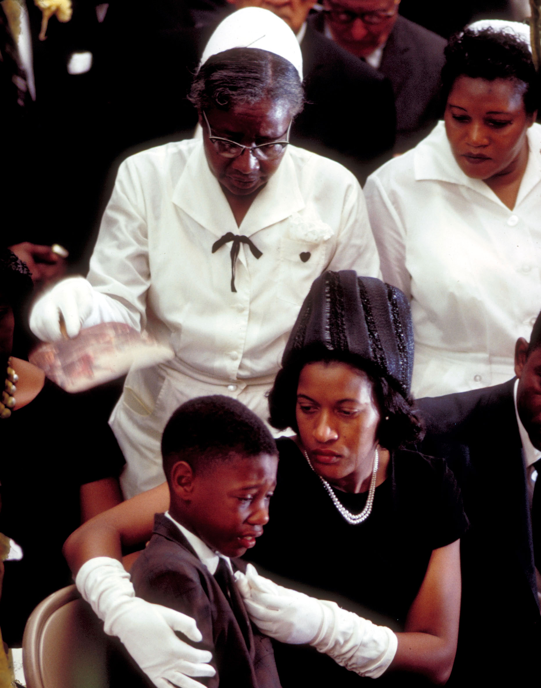 Myrlie Evers comforts her son, Darrell Kenyatta Evers, at the funeral of murdered civil-rights activist Medgar Evers, June 15, 1963.