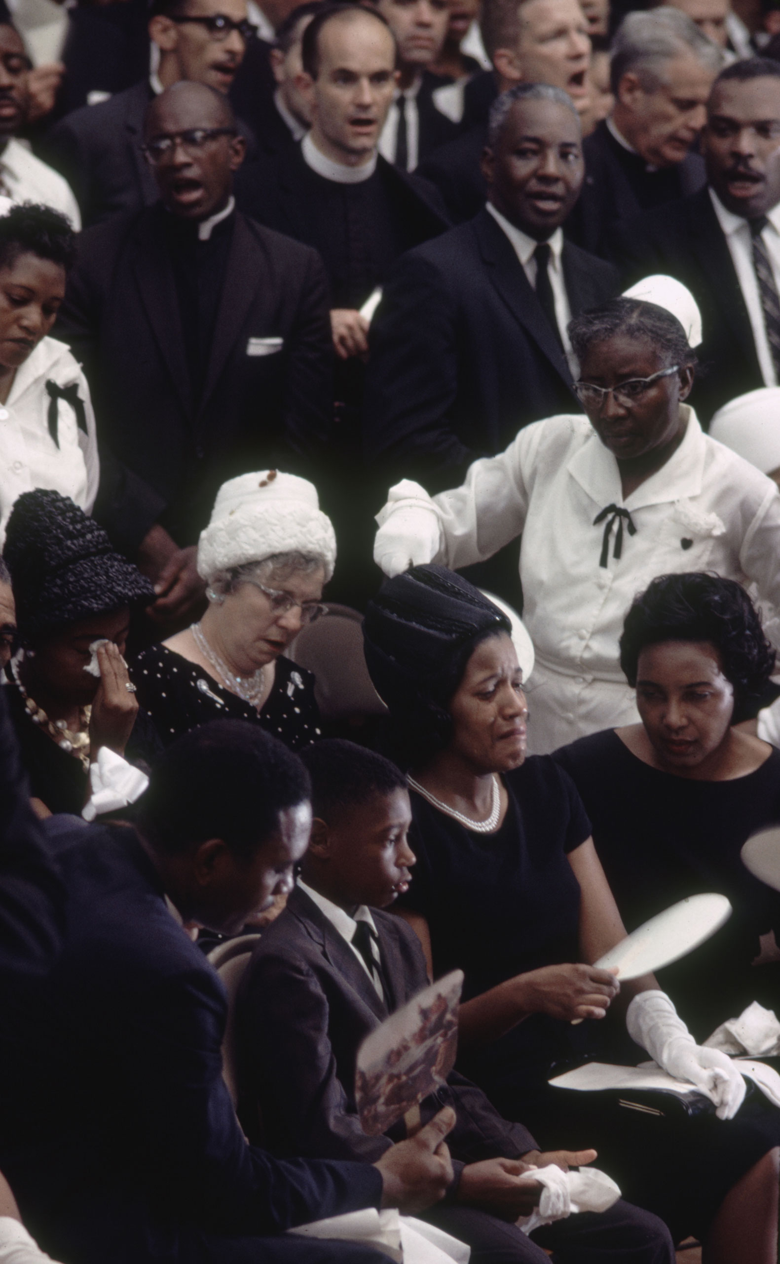 Myrlie Evers (front row, second from right), wife of Medgar Evers; her son, Darrell Kenyatta; and other mourners at Medgar Evers' funeral, Jackson, Miss., June 15, 1963.