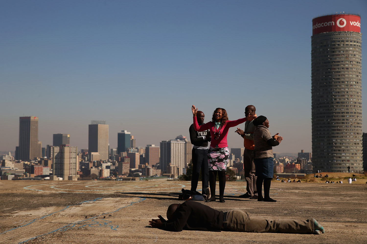 June 21, 2013. Worshipers sing and pray on top of an unfinished building on a hill overlooking downtown in the Yeoville neighborhood in Johannesburg, South Africa.