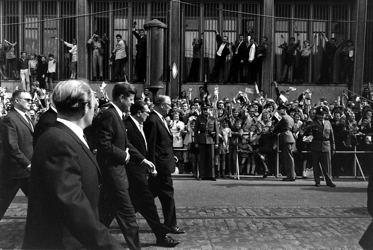 President John F. Kennedy walks with dignitaries during his June 1963 visit to Germany.