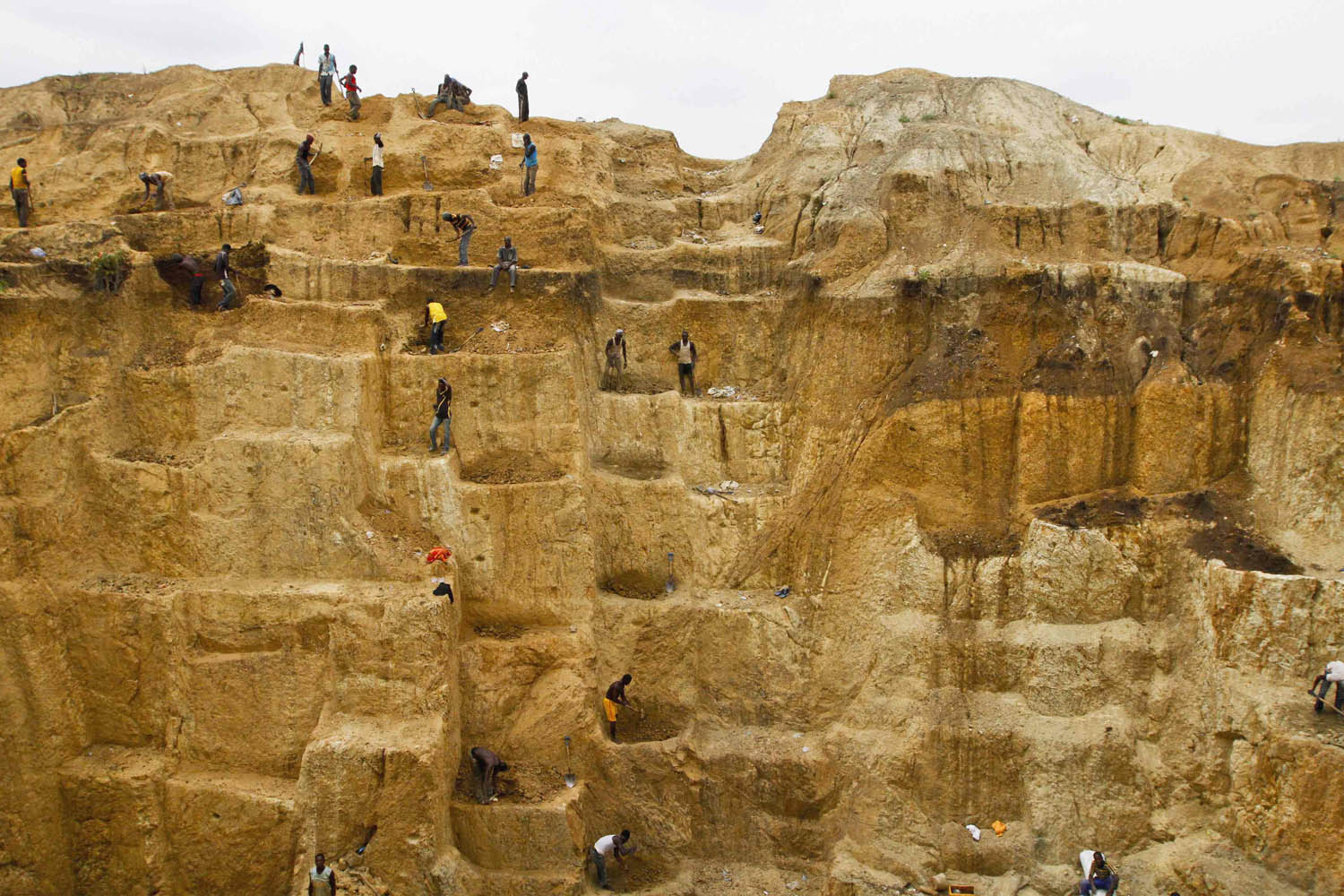 Labourers work at a mine believed to contain gold in Minna