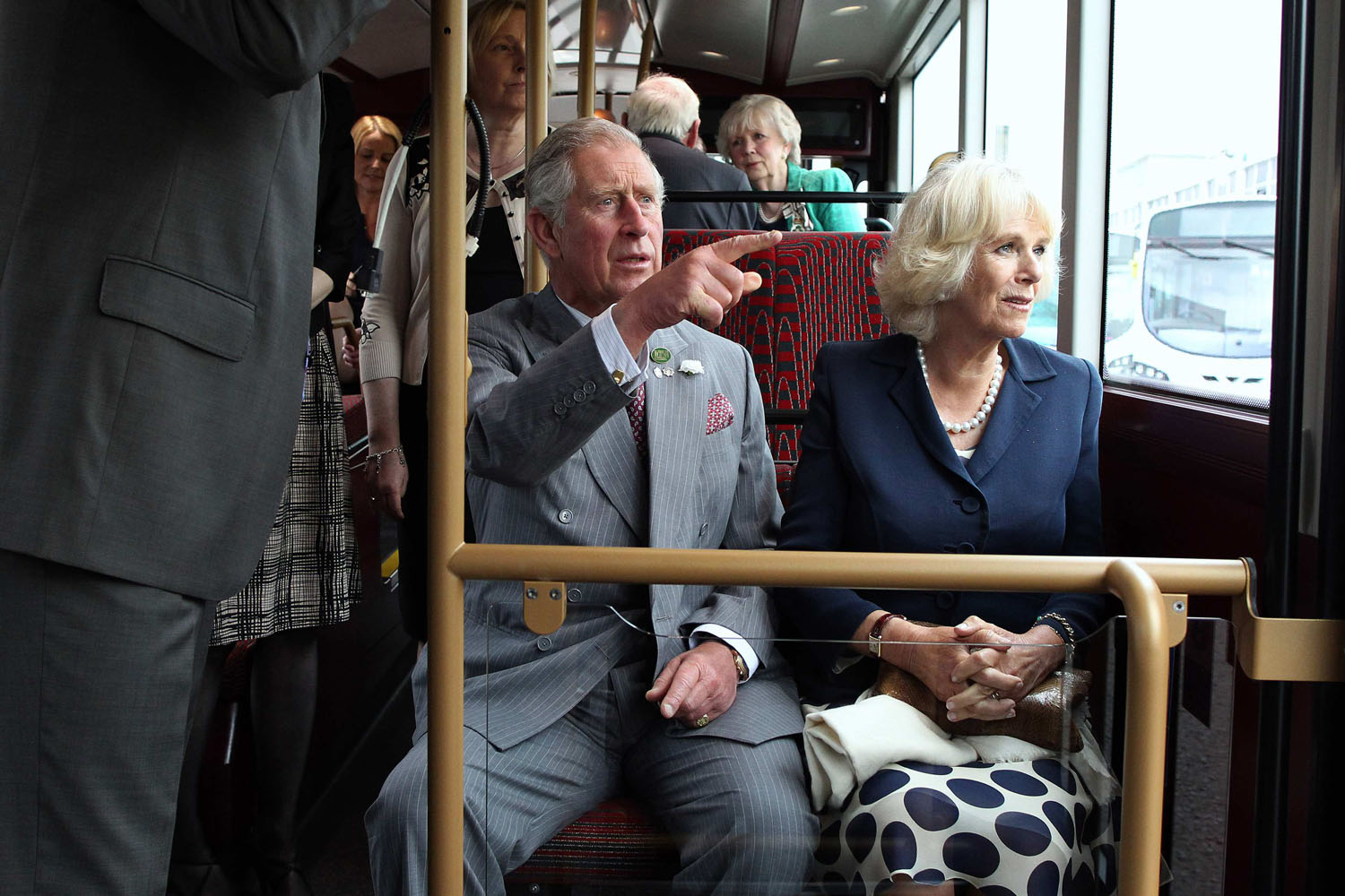 June 25, 2013. Britain's Prince Charles and his wife Camilla, Duchess of Cornwall take a short ride on a bus during their visit to the Wrightbus factory in Ballymena, Northern Ireland.