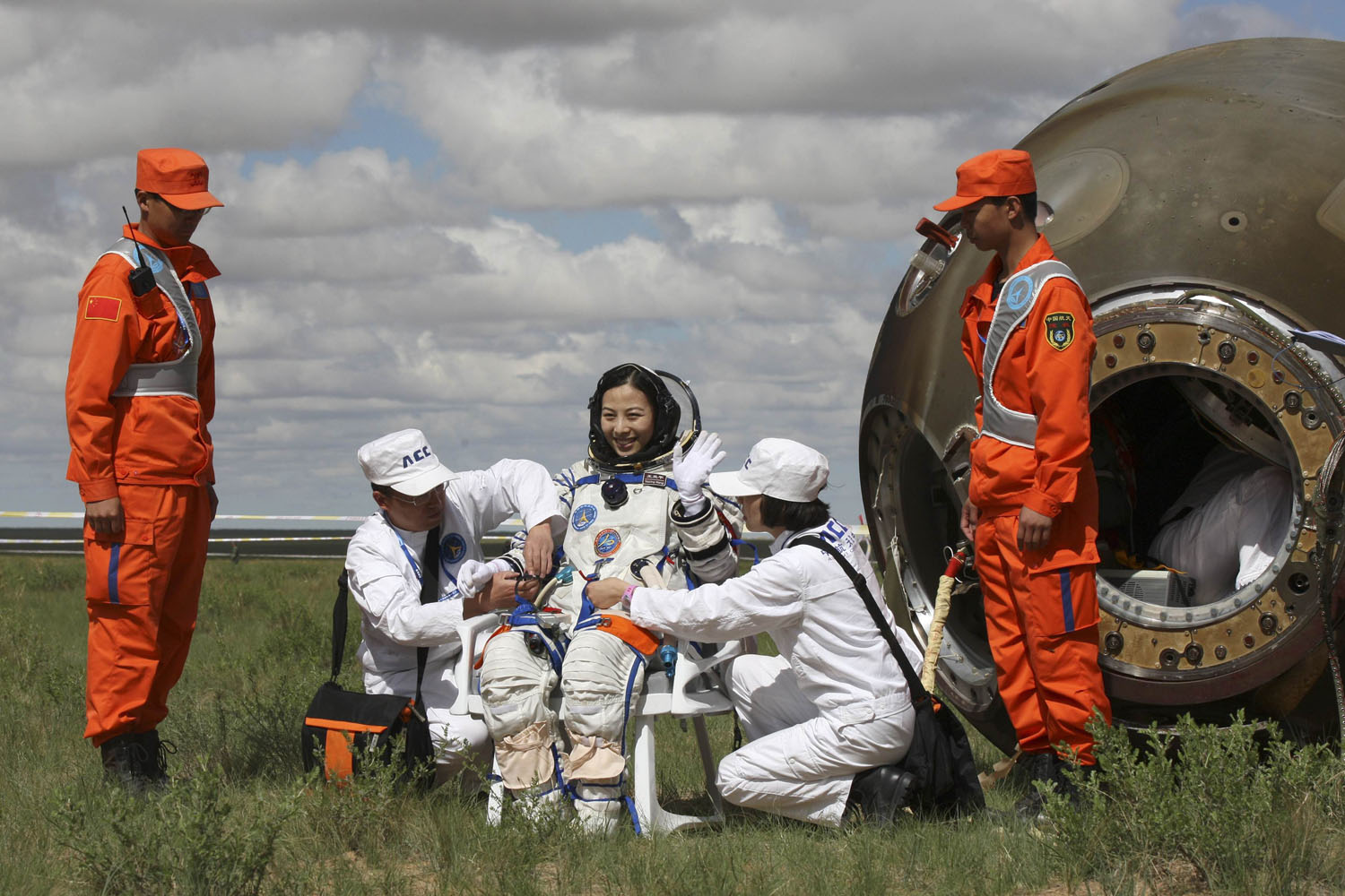 Chinese astronaut Wang waves after she gets out from re-entry capsule of China's Shenzhou-10 spacecraft returning to earth at its main landing site in north China's Inner Mongolia Autonomous Region
