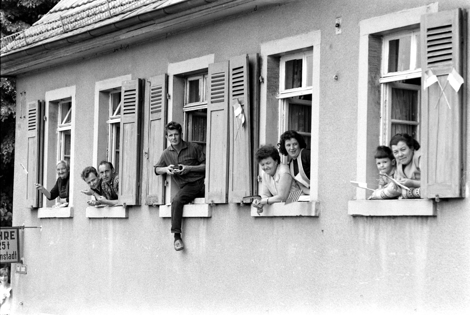 People watch from windows during President John F. Kennedy's June 1963 visit to Germany.