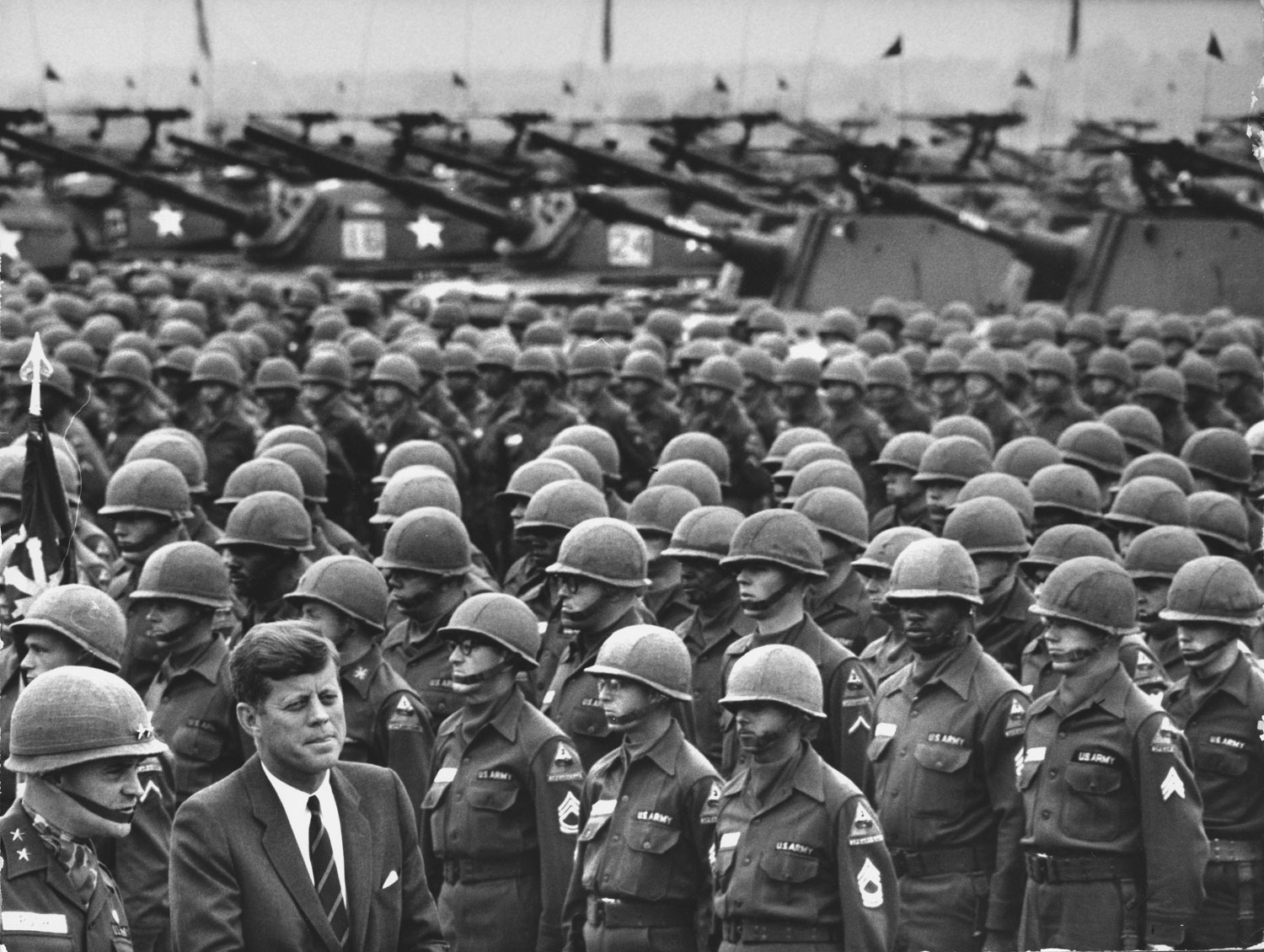 President John F. Kennedy (right), with Major General John R. Pugh (left), reviews the U.S. Army's 3rd Armored Division ("Spearhead"), West Germany, June 1963.