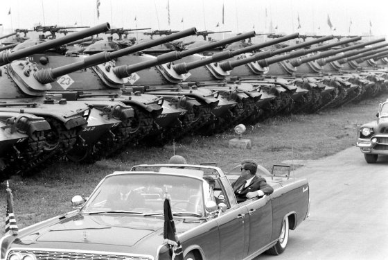President John F. Kennedy, in open limo, reviews the U.S. Army's 3rd Armored Division (