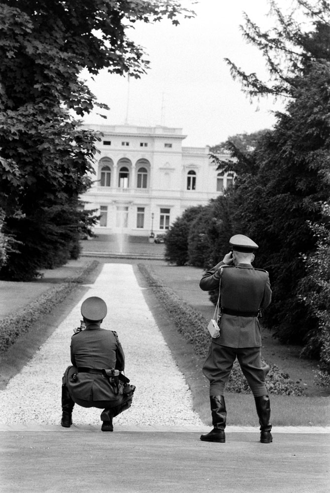 West German police officers take snapshots of governmental building during President John F. Kennedy's June 1963 visit.