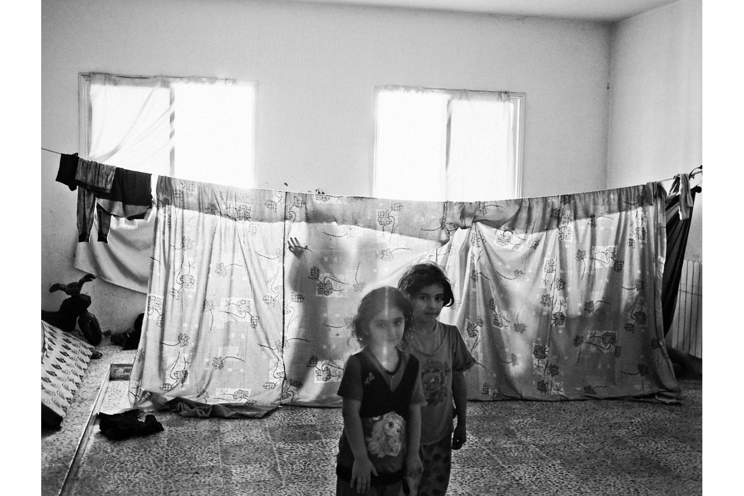 Tekrit, north Lebanon. June 2013.A Syrian family in a classroom that is not their home in a school occupied by Syrian refugees in the village of Tekrit, north Lebanon.(Photo by Moises Saman/MAGNUM)