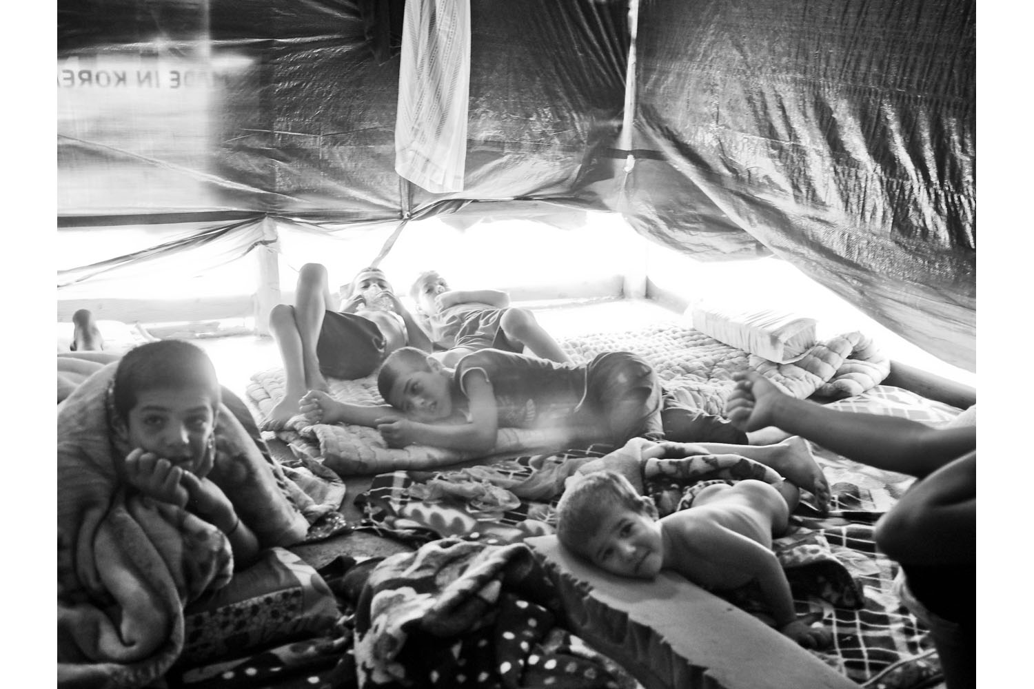 Al Marj, Bekaa Valley, Lebanon. June 2013.Syrian children inside their tent in the Al-Jarrah tent settlement in the Bekaa Valley, Lebanon.(Photo by Moises Saman/MAGNUM)