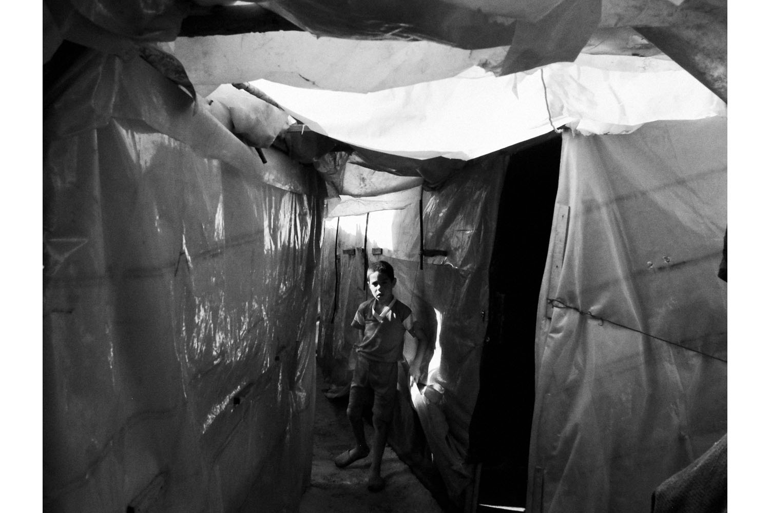 Al-Muhamra, north Lebanon. June 2013.A Syrian boy inside the Al-Muhamra tent settlement in north Lebanon.(Photo by Moises Saman/MAGNUM)
