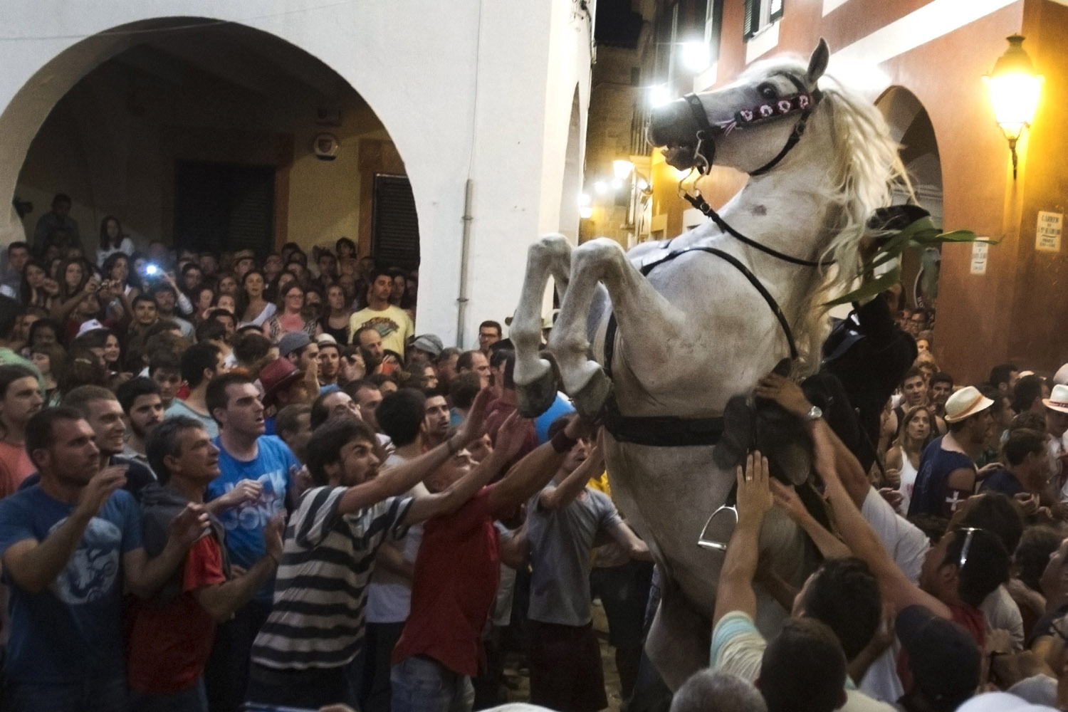 June 23, 2013. A horse rears in a crowd during a horse parade of the traditional San Juan's (Saint John) festival in the town of Ciutadella, on the Balearic Island of Menorca, on the eve of Saint John's day.
