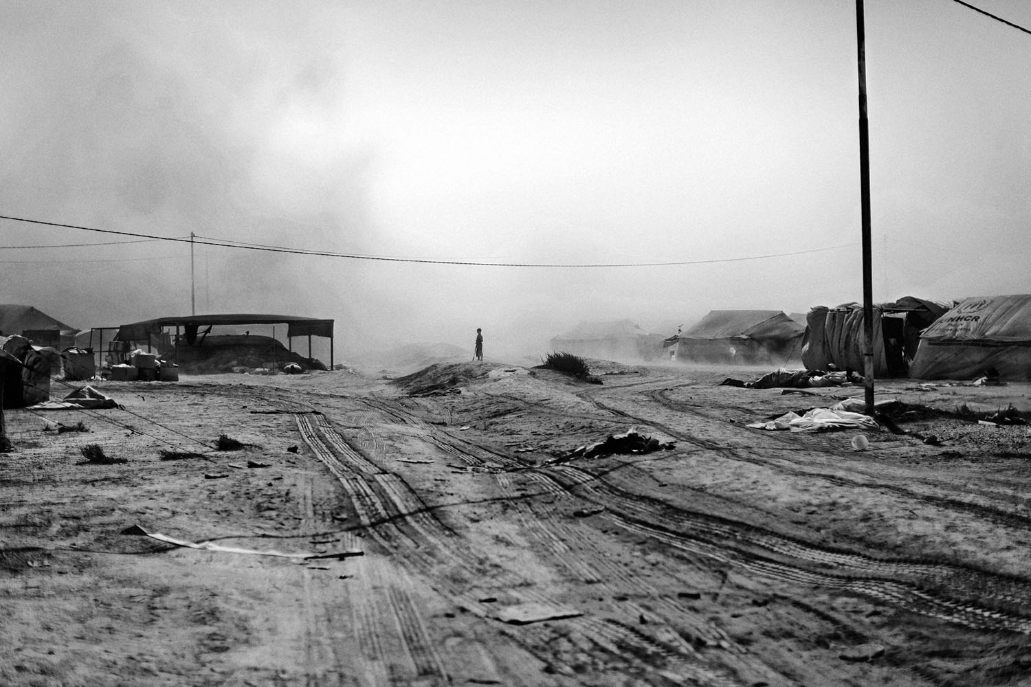 JORDAN, Zaatari. September 1, 2012.Dust sweeps over the Zaatari refugee camp near the Syrian border in Jordan. The camp was first opened in July 2012 to host the Syrians fleeing the violence that erupted in 2011 and 2012. As of late August 2012 the camp houses 15,000 Syrian refugees.Contact email:New York : photography@magnumphotos.comParis : magnum@magnumphotos.frLondon : magnum@magnumphotos.co.ukTokyo : tokyo@magnumphotos.co.jpContact phones:New York : +1 212 929 6000Paris: + 33 1 53 42 50 00London: + 44 20 7490 1771Tokyo: + 81 3 3219 0771Image URL:http://www.magnumphotos.com/Archive/C.aspx?VP3=ViewBox_VPage&IID=2K7O3RKHMV0Z&CT=Image&IT=ZoomImage01_VForm