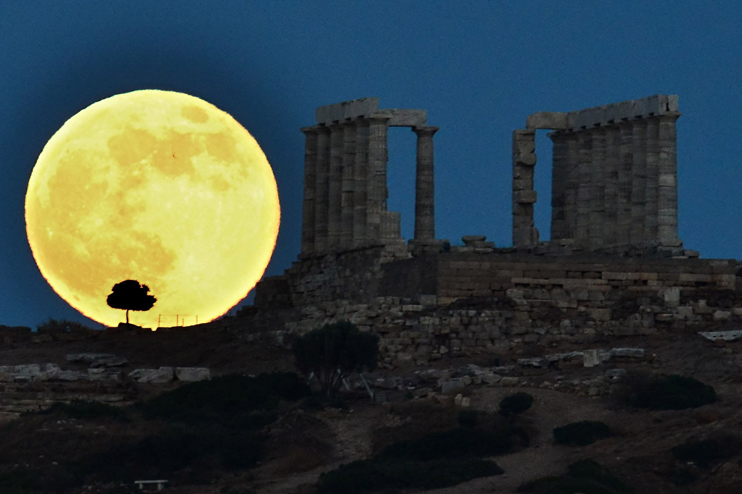 June 23, 2013. A supermoon rises next to the ancient Greek temple of Poseidon at Cape Sounion, Greece.