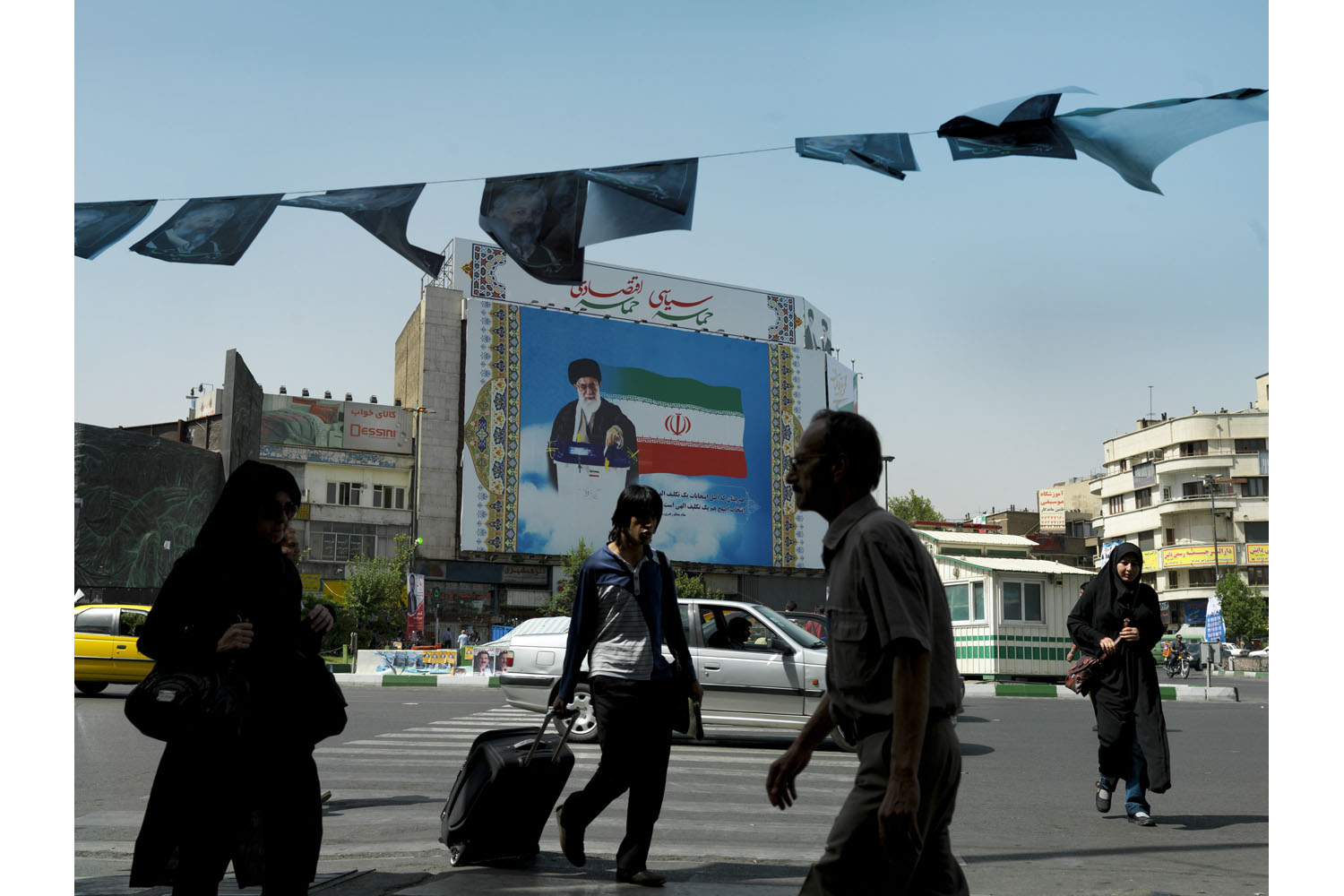 A poster of Ayatullah Ali Khamenei looms over Tehran's Enghelab Square.