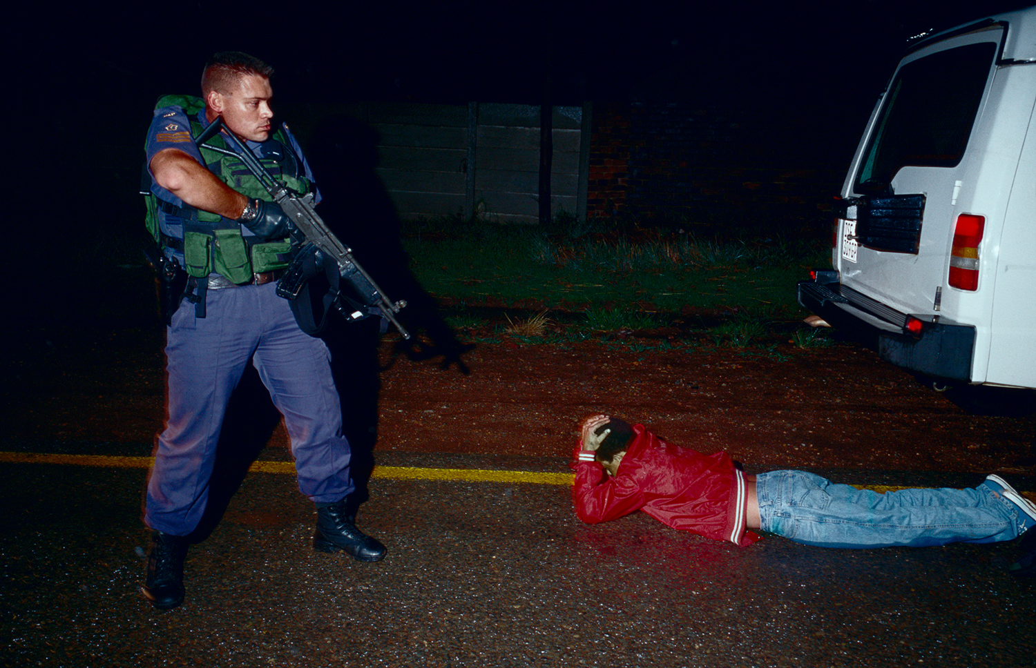 Daniel Lieberman, a Flying Squad police officer arrests a suspected car thief on outside Soweto, Johannesburg, South Africa, March 1999. Flying Squad is a rapid response unit working in South Africa's larger cities, and they have a reputation for being hard on suspected criminals. South Africa has some of the highest crime statistics in the world, especially in carjackings, armed robberies and rape.