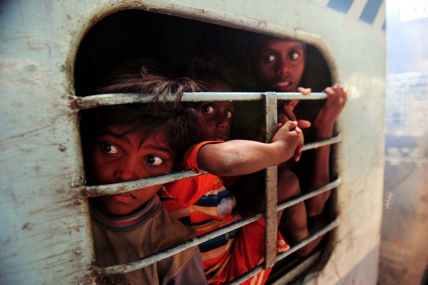 June 22, 2013. Young Indian commuters sit inside a crowded train compartment at Allahabad junction in Allahabad.