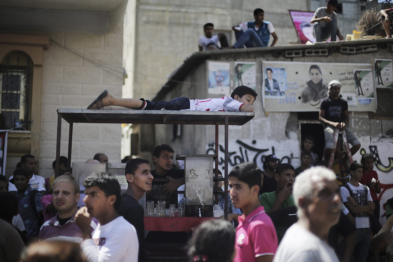 June 25, 2013. People wait for Arab Idol winner Mohammed Assaf (not pictured) in front of his family house at the Khan Younis refugee camp in the southern Gaza Strip.