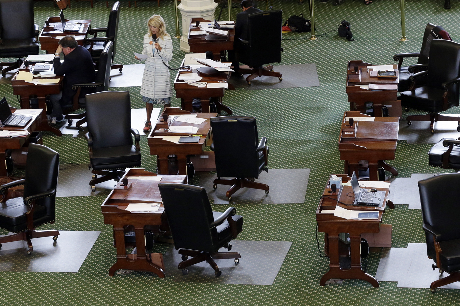 June 25, 2013. Sen. Wendy Davis, D-Fort Worth, stands on a near empty senate floor as she filibusters in an effort to kill an abortion bill in Austin, Texas.