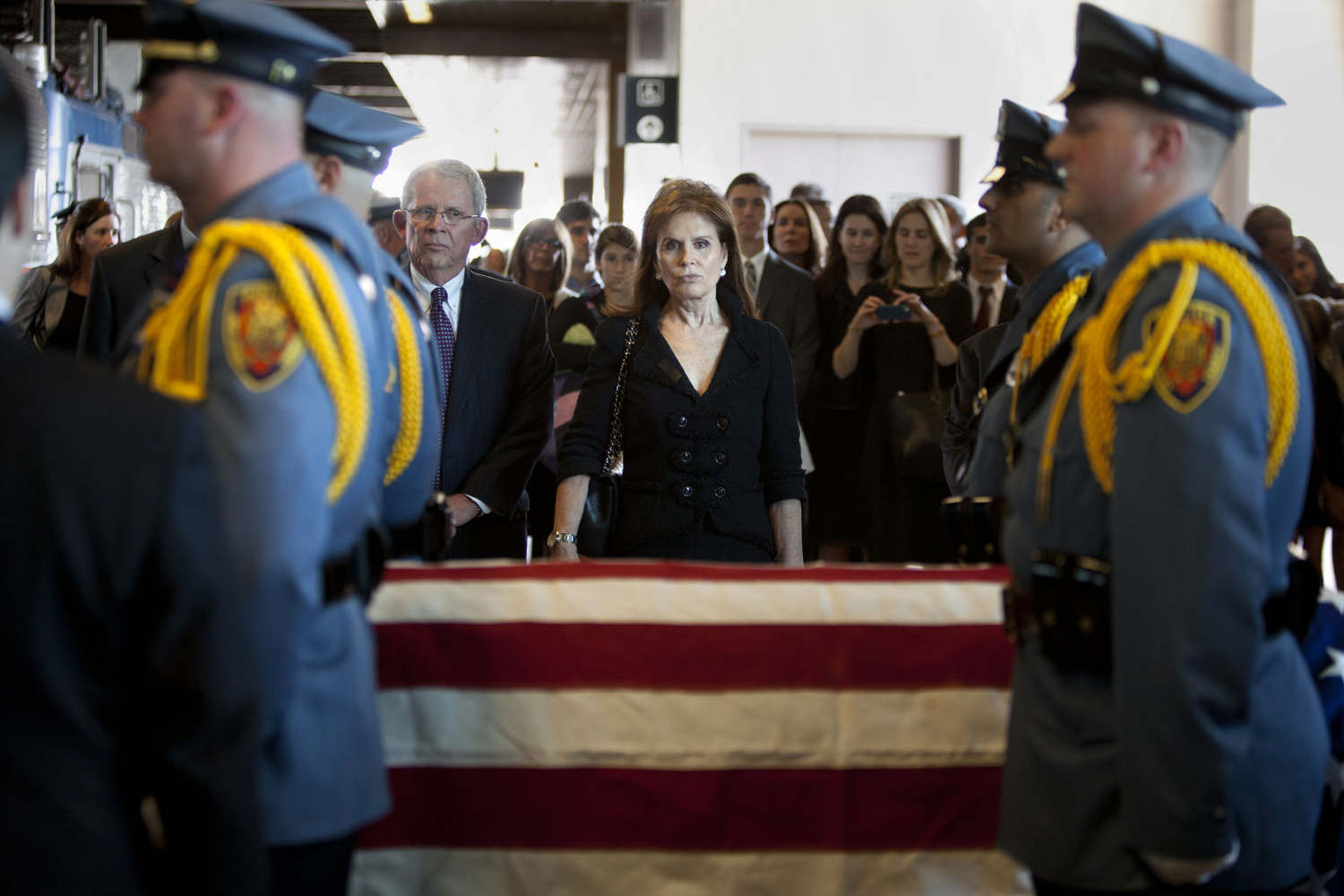 Senator Frank Lautenberg's widow looks on as his casket is wheeled onto a train, in Secaucus, New Jersey