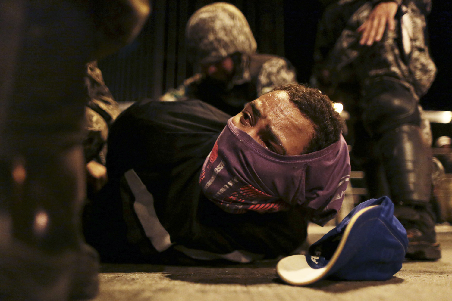 June 26, 2013. A demonstrator is detained by the police during a protest on the streets of Belo Horizonte, Brazil.