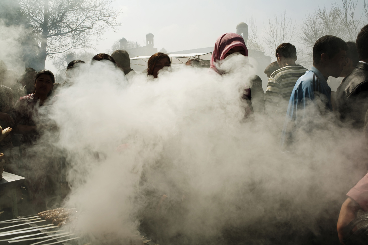 Smoke and people fill the park of Khudayar Khan’s palace to celebrate Nowruz, the new year and beginning of spring, on March 21.
                              Kokand, Uzbekistan