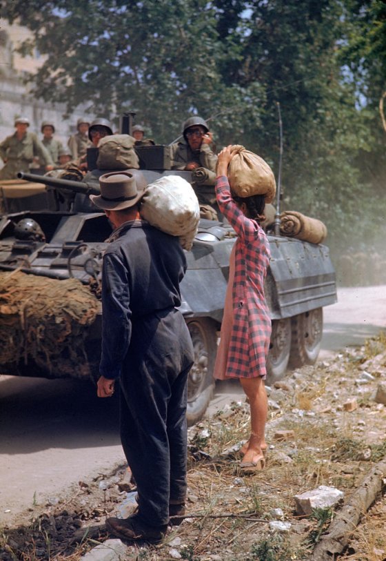 Italians watch American armor pass during the drive towards Rome along the Appian Way, World War II.