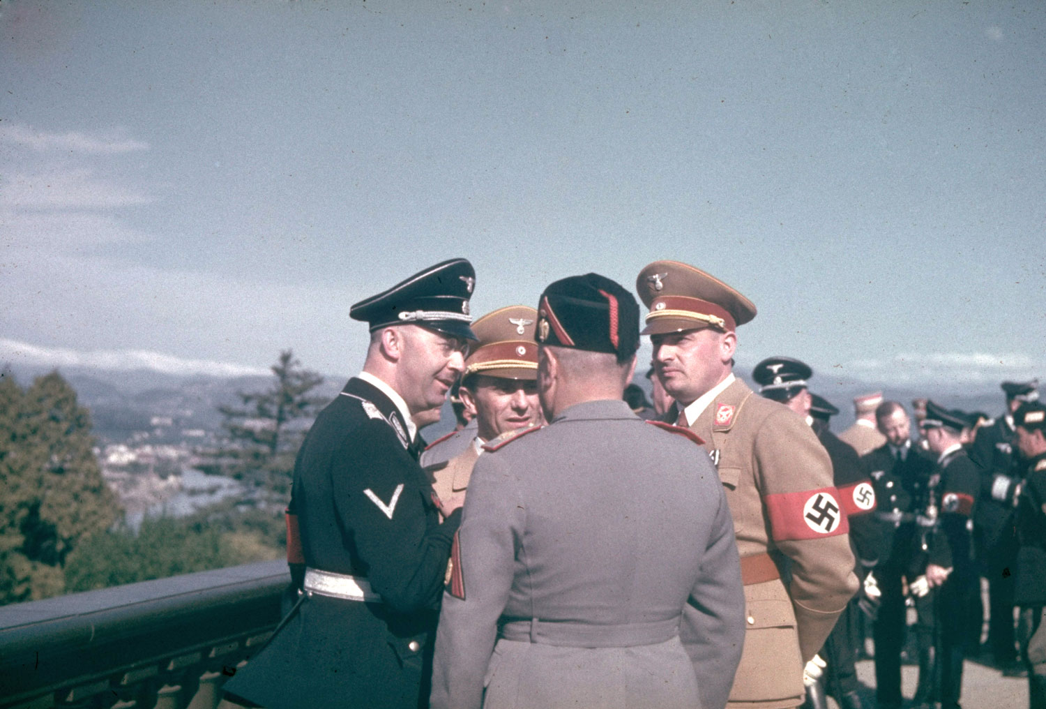 High-ranking Nazi and Italian Fascist officials, including Heinrich Himmler (left) and Mussolini (back to camera), at Santa Marinella, north of Rome, during Adolf Hitler's 1938 state visit to Italy.