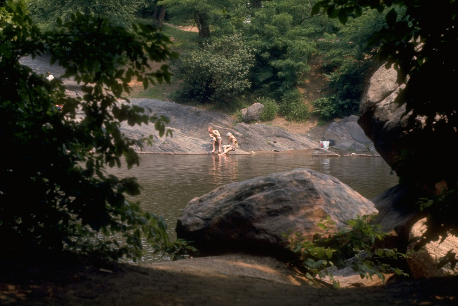 People relaxing on rocks in Central Park, 1969.