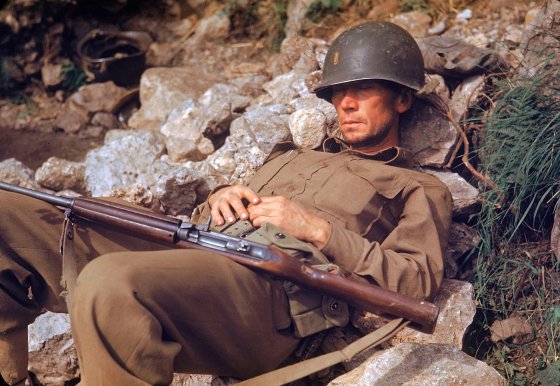 An American soldier sleeps on a pile of rocks during the drive towards Rome, 1944.