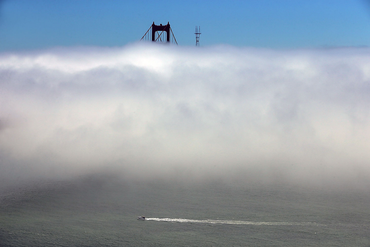 June 28, 2013. A boat cruises under a bank of fog near the Golden Gate Bridge in San Francisco.