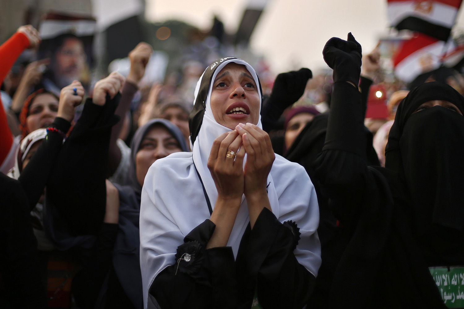 supporter of deposed Egyptian President Mohamed Mursi attends a protest outside the Rabaa Adawiya mosque in Cairo