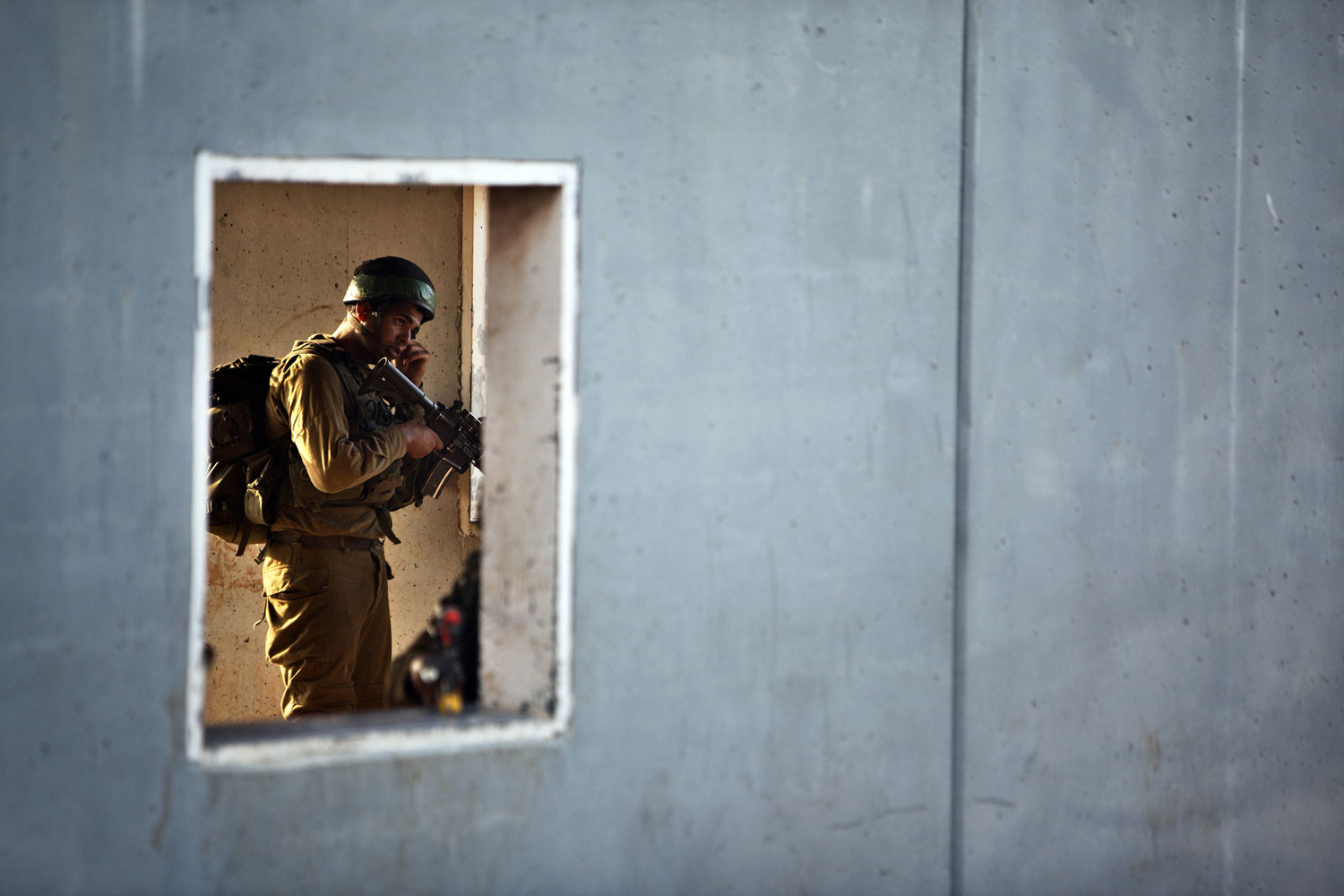 An Israeli soldier takes part in drill simulating a battle with Hezbollah in a mock village at base near Haifa