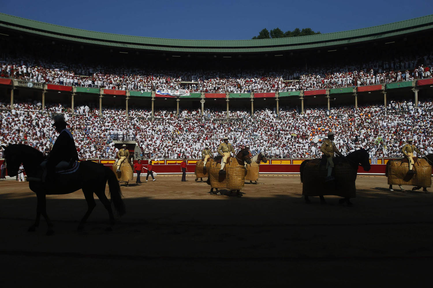 Picadores enter the bull ring at the start of the fifth bullfight of the San Fermin festival in Pamplona