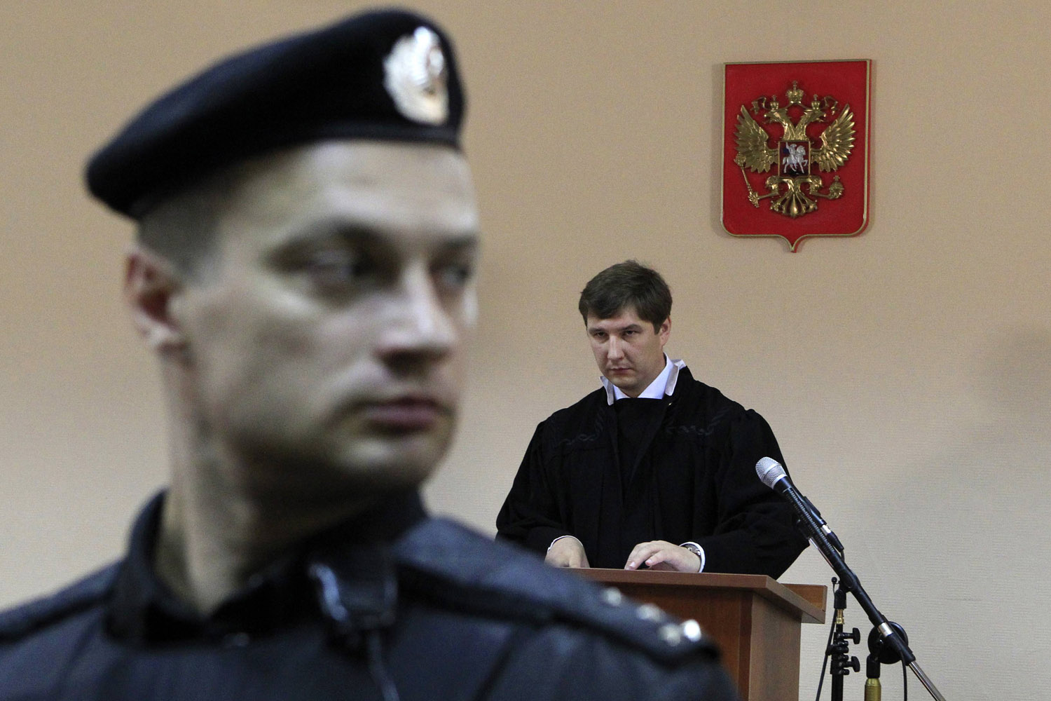 July 18, 2013. Judge Sergei Blinov (back) reads the verdict during the hearing of the Alexei Navalny trial in Kirov, Russia.