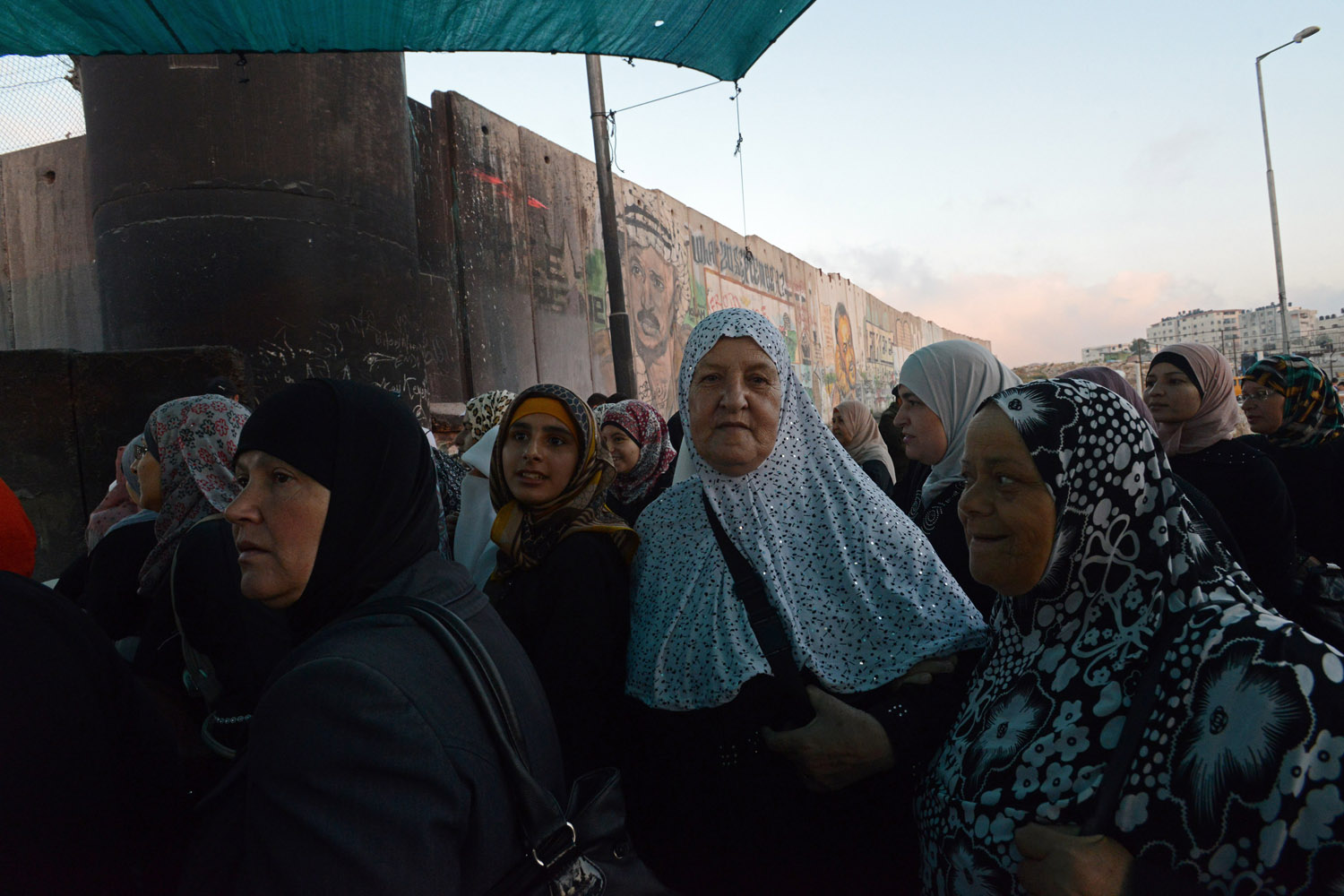 July 12, 2013. Palestinians from the West Bank wait to cross the Qalandiya Checkpoint  on their way to pray in Jerusalem on the first Friday  of the Muslim holy month of Ramadan.