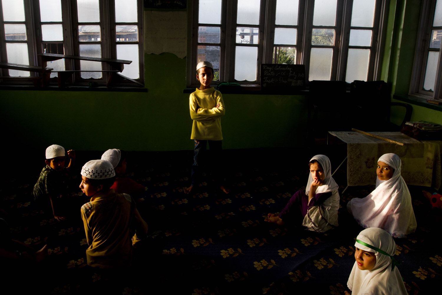 July 17, 2013. Kashmiri Muslim children attend recitation classes of the Quran at a local Madrasa or Muslim religious school, during Ramadan in Srinagar, India.