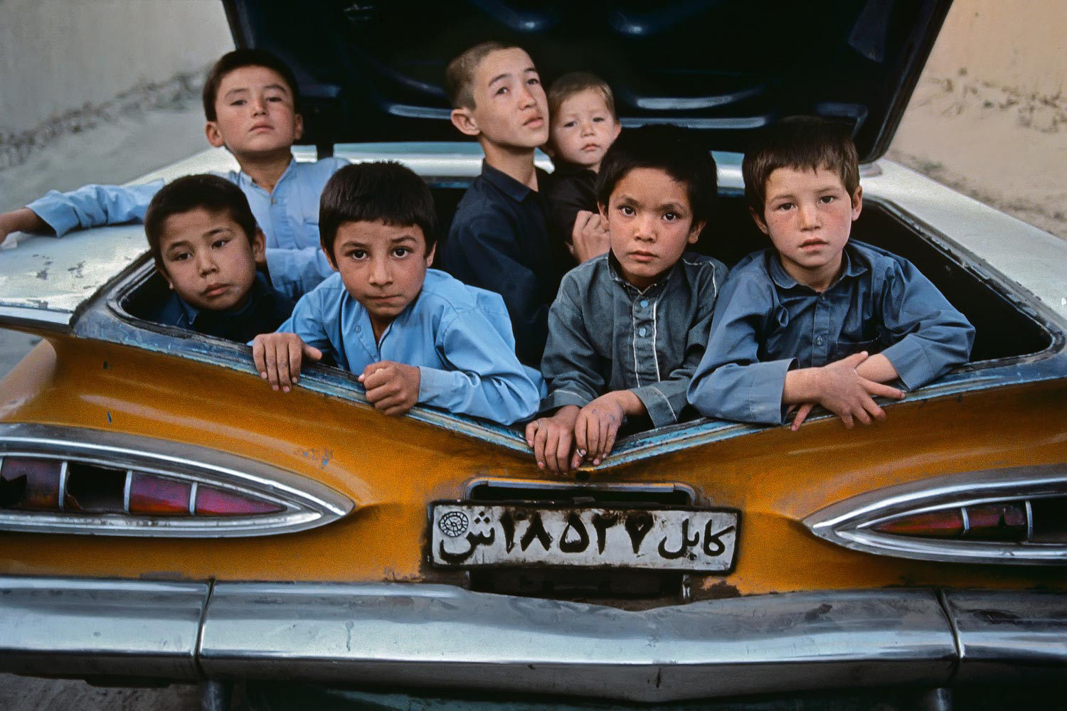 Boys in the boot of a taxi, Kabul, Afghanistan, 1992
                              
                              
                              Concerned about the plight of the Hazara people of Afghanistan, McCurry helped establish a non-profit called ImagineAsia. ‘It’s an attempt to get warm clothes, textbooks, pencils and notebooks to the Bamiyan region of Afghanistan, where the Hazara people live. Maybe most significantly, we’ve helped to set up classes for children and their mothers in Kabul. In addition, ImagineAsia has sponsored a young Hazara woman who is studying for a university degree in the United States.’