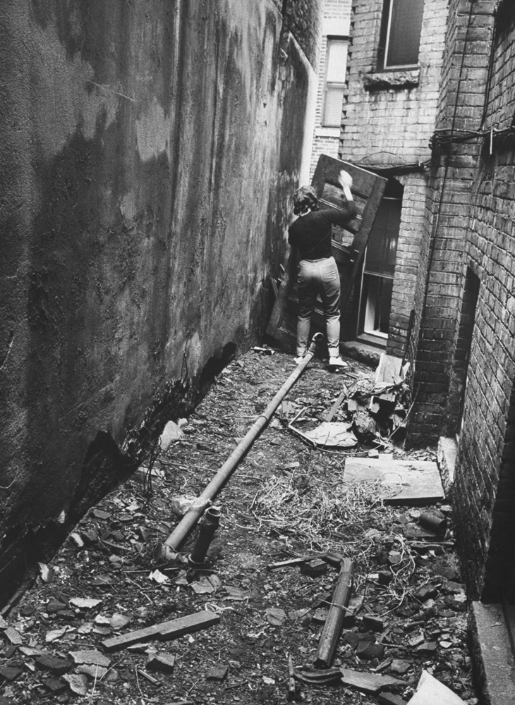 Girl barricading alley outside apartment during series of Boston stranglings, 1963.