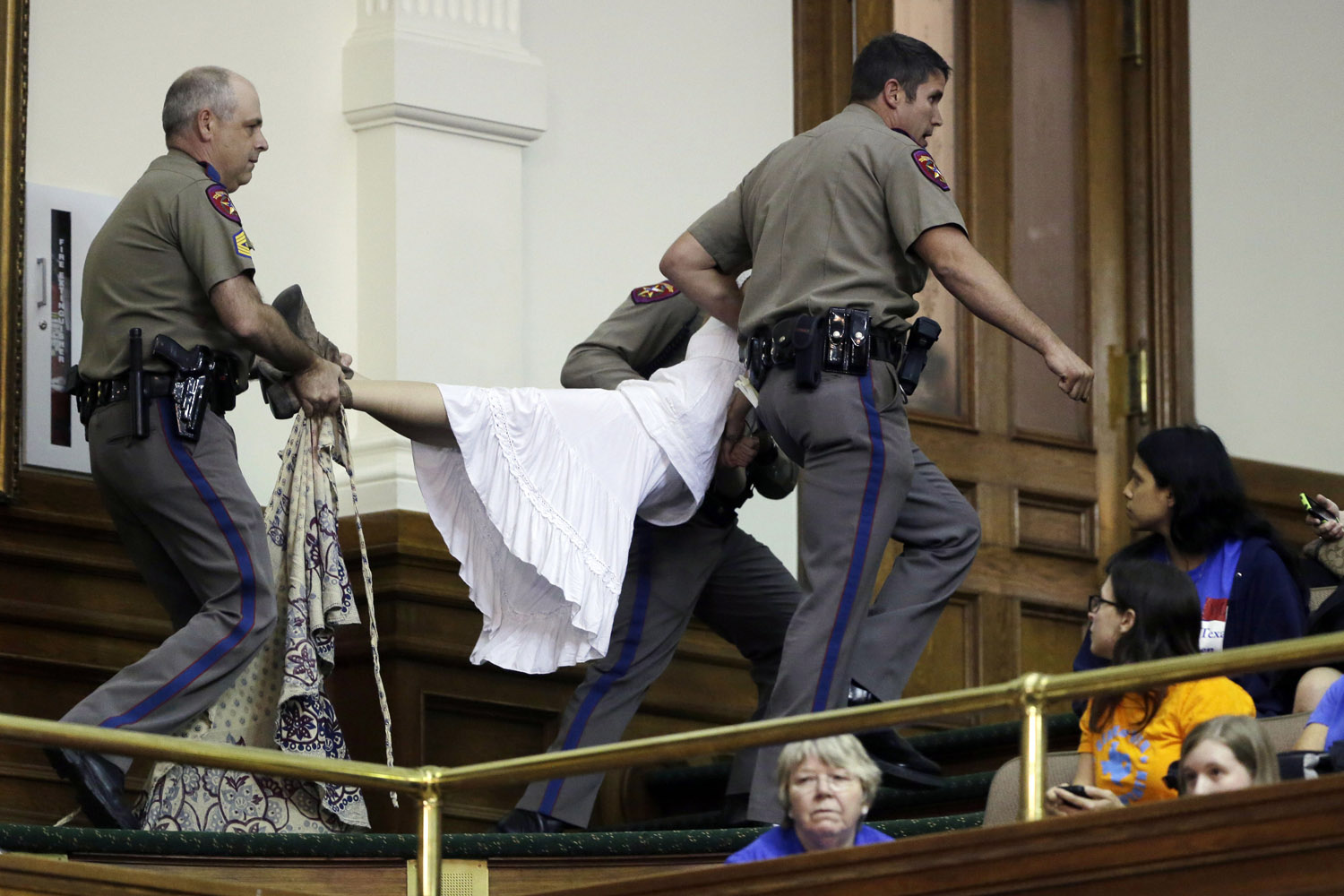 July 12, 2013. A pro-abortion rights protester is removed from the Texas Senate gallery by Texas state troopers as the Senate debates an abortion bill in Austin, Texas.