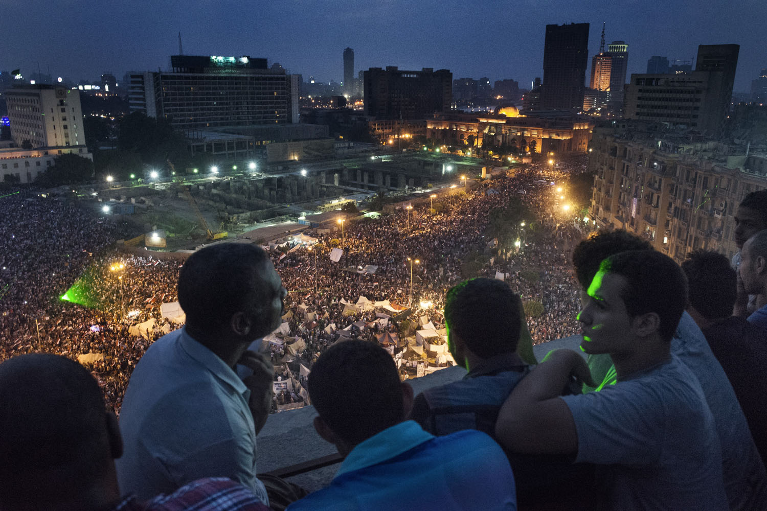 July 3, 2013. People look on as crowds celebrate in Tahrir Square in Cairo,  after Egyptian President Mohamed Morsi is removed from power by the military
