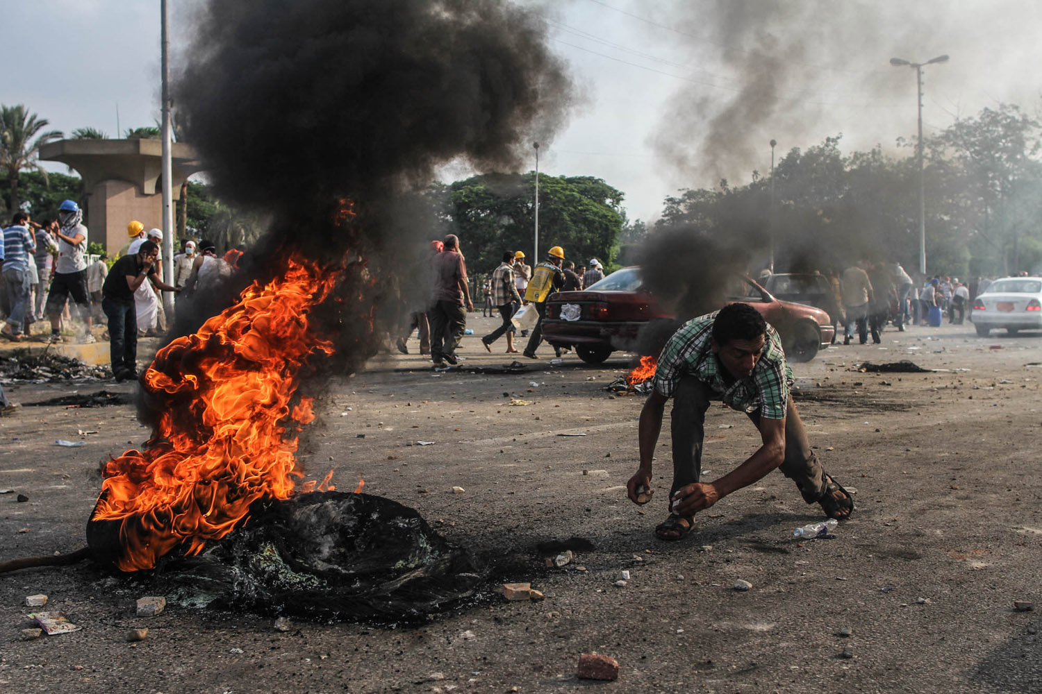 A Morsi supporter grabs rocks during clashes with police forces near the Rabaa sit-in.