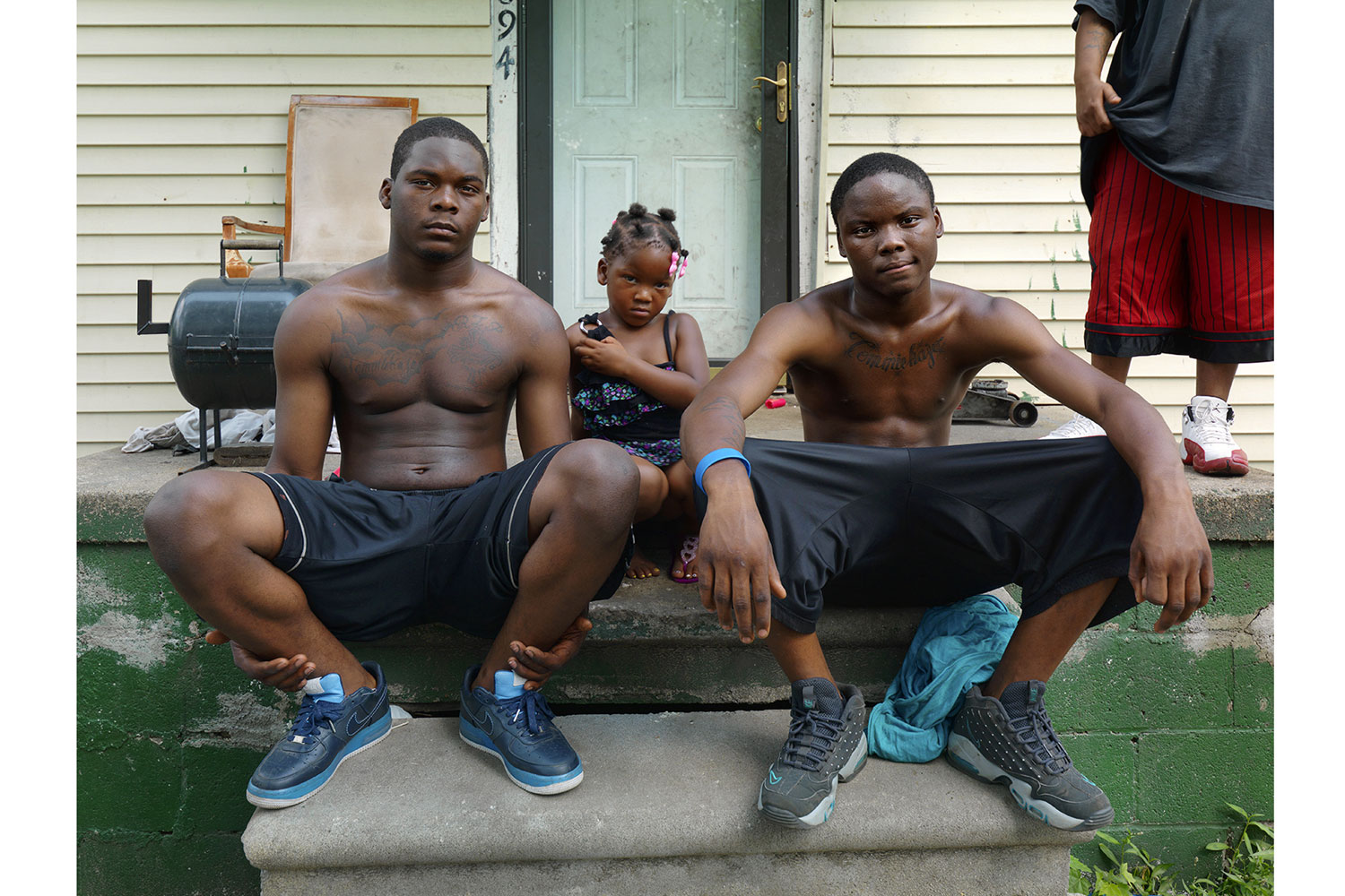 Marcus and Bey-Bey, Eastside, Detroit, 2012
                              
                              Two brothers with tattoos on their chests memorializing the death of their mother who died from an asthma attack at the age of 34.