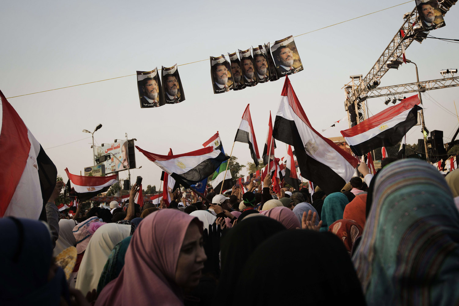 July 15, 2013. Muslim Brotherhood members and supporters of deposed president Mohammed Morsi wave national flags shouting slogans during a rally in his support outside Rabaa al-Adawiya mosque in Cairo, Egypt.