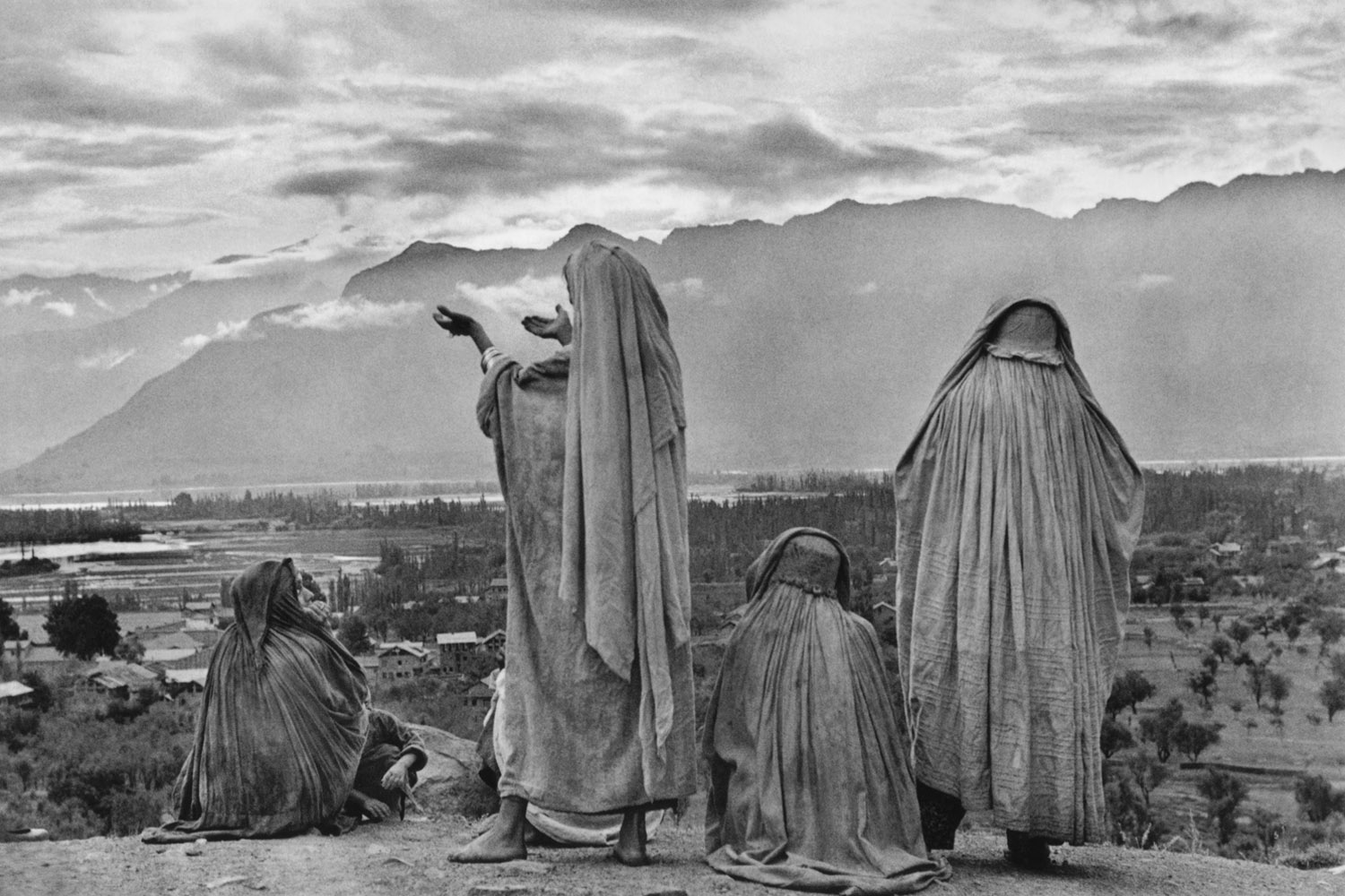 Muslim women on the slopes of Hari Parbal Hill, praying toward the sun rising behind the Himalayas in Srinagar, Kashmir, 1948.