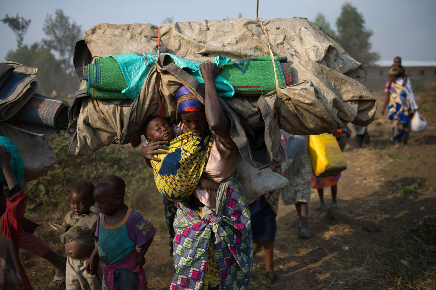 July 15, 2013. Displaced Congolese flee the area of Kanyarucinya through Munigi on the outskirts of Goma in the east of the Democratic Republic of the Congo.